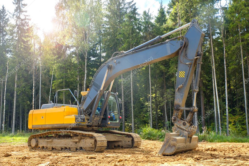 Industrial road construction site, highway building. Heavy duty machinery excavator on site