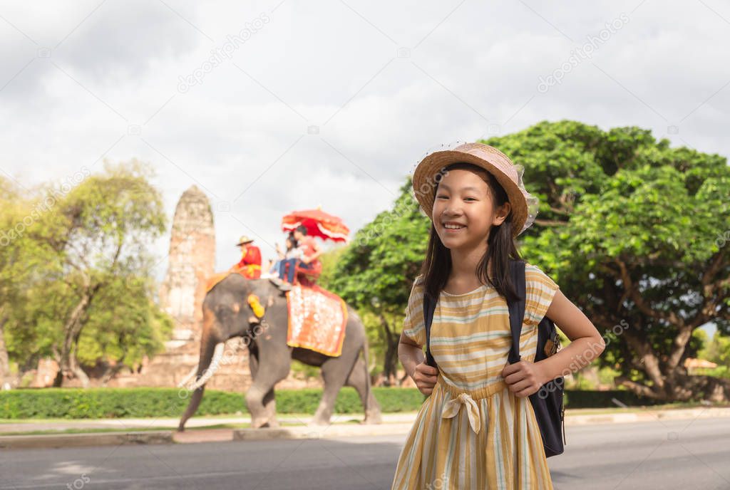 Asian girl smile happily,tourists on an ride elephant tour background,Ayutthaya,Thailand,summer vacation,travel concept.