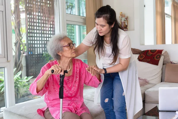 Cuidador Joven Que Apoya Mujer Discapacitada Mayor Con Bastón — Foto de Stock