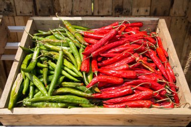 Yığın biber biber, organik çiftlik Satılık Ahşap kutu üzerinde kırmızı ve yeşil biber