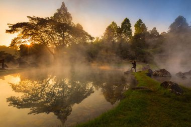 Chaeson National Park,Lampang,Thailand,The heat from the hot spring providing a misty and picturesque scene which is particular beautiful in the morning clipart