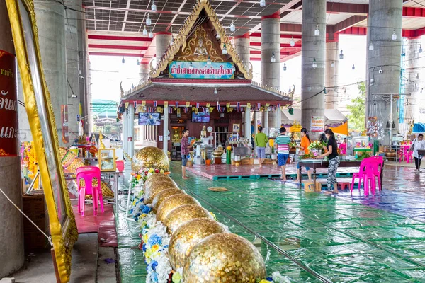 Samut Sakhon,Thailand-May 13,2019:Wat Krok Krak,inside the  church there is a buddha,the ancient golden buddha statue wearing black glasses with dark lenses,is a place and sacred buddha image that is popular with local people and tourisits — Stock fotografie