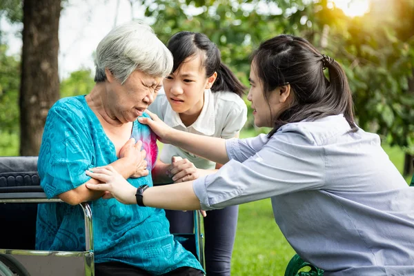 Asiática abuela mayor que tiene trastorno de pánico que sufre un ataque de ansiedad con las manos en el pecho sensación de miedo, problemas de salud mental, depresión anciana que tiene latidos del corazón rápido, palpitaciones, falta de aliento en el parque — Foto de Stock