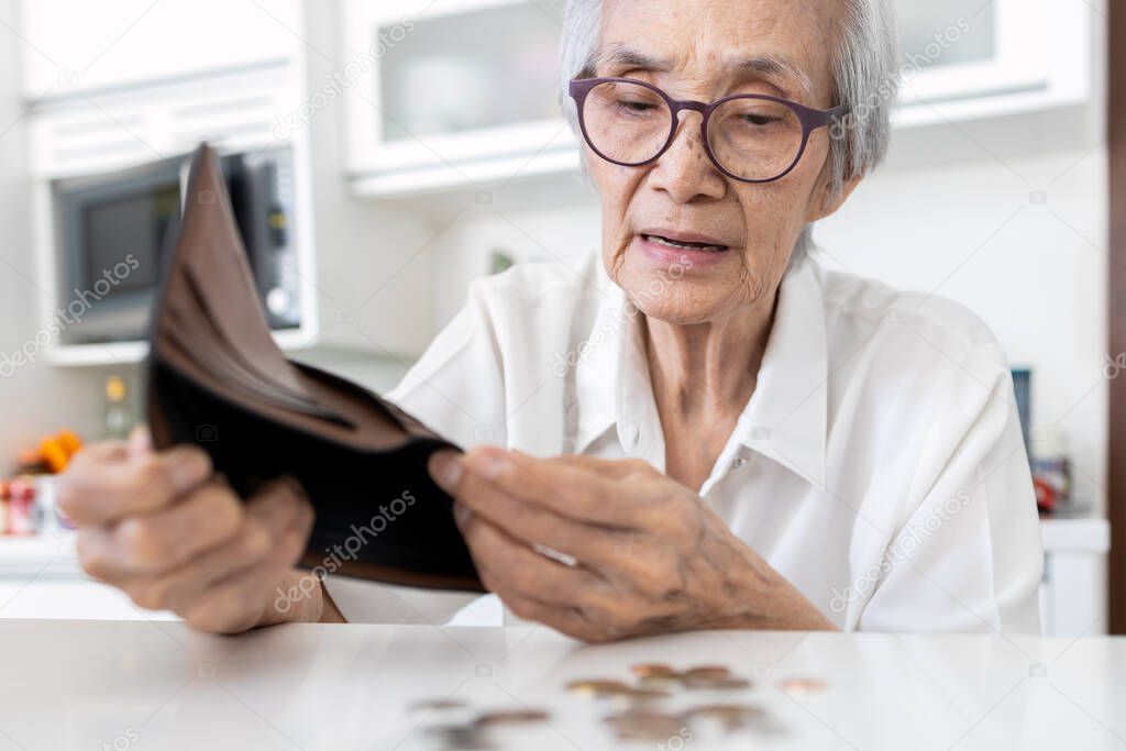 Concerned senior woman holding empty wallet,old elderly people shaking out coins from wallet,last remaining money coins,financial problems,investment,planning savings,no retirement savings,poverty