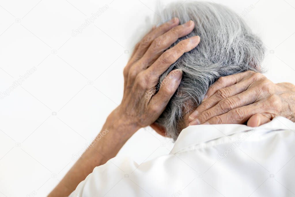 Asian senior woman suffering from scruff pain,occipital bone,stiffness neck,elderly female with painful in the nape of the neck and headache,infectious disease or symptoms of meningitis,brain tumor