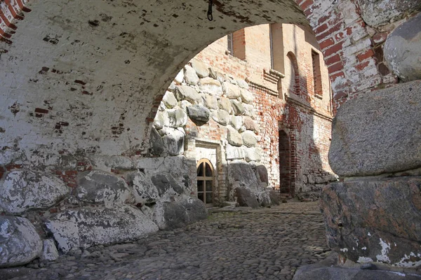 Courtyard with walls of large boulders and brick walls of the old monastery