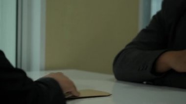 Close up of businessman giving money to another man on the table. bribery, usury and corruption concepts