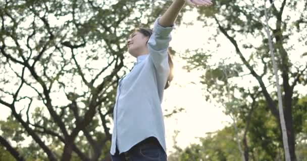 Porträtt av unga attraktiva asiatisk kvinna med glada känslor i en sommar park. — Stockvideo