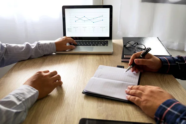 Businessman using laptop to teach and  analysis the situation on the market value , Business concept