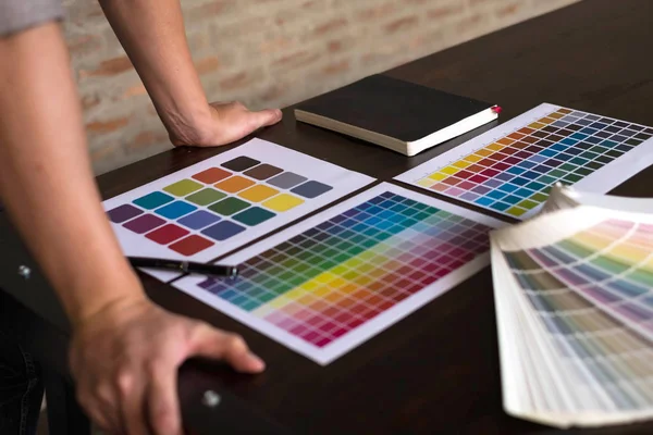 Graphic designers choose colors from the color bands samples for design .Designer graphic creativity work concept .