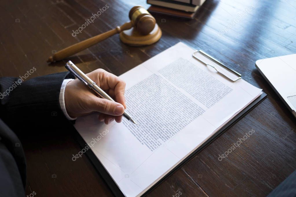 Lawyer working with contract papers on the table in office. consultant lawyer, attorney, court judge, concept.