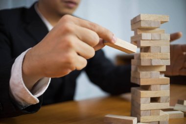 İş adamları eksik Domino doldurmak için ahşap bloklar alıyor. Gr