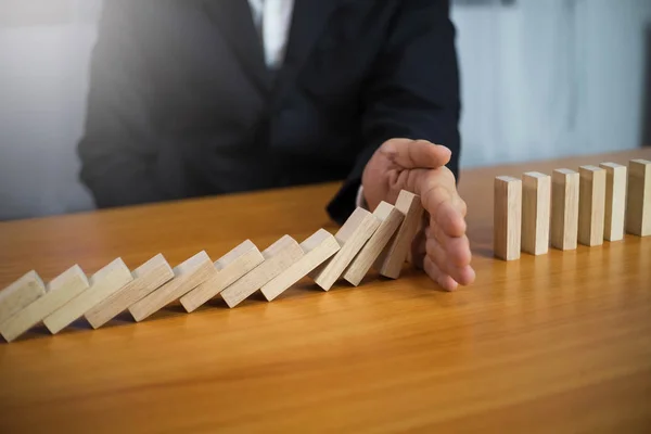 Businessman hand stops domino continuous overturned meaning that — Stock Photo, Image