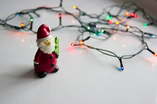 Santa Claus Figurine Garlands White Table — Stock Photo, Image