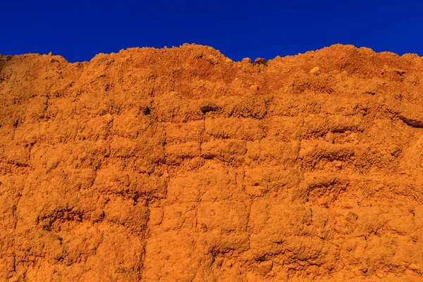 Wall of adobe, earth, mud, straw, pressed. Old, traditional and sustainable construction. Eroded by the passage of time and weather.