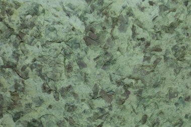 El yapımı kağıt doku geri dönüşümlü malzemeler, ağaç yaprakları ve pamuk lifleri ile. Hassas tonları, koyu sarı, yeşil ve karanlık ışık.