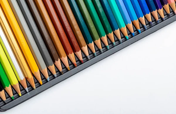 Colored pencils texture. Foreground. Colors of autumn and winter. Start of school, of classes. Beautiful wallpaper. Color range of ocher, green brown, turquoise and blue. Isolated on white background.