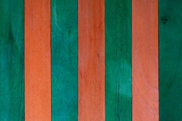 Beautiful texture of natural wood slats of orange and green colors. Natural and aged appearance. — Stock Photo, Image