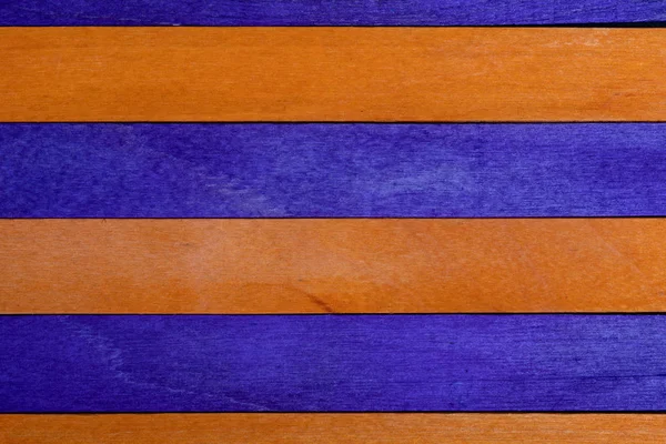 Beautiful texture of natural wood slats of orange and purple colors. Natural and aged appearance. — Stock Photo, Image