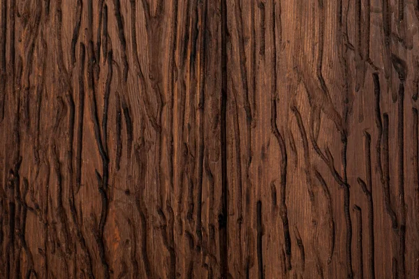 Textura de madeira preciosa. De aspecto rústico e escuro, ocre, marrom, tostado, tons pretos. As veias e nós são apreciados. — Fotografia de Stock