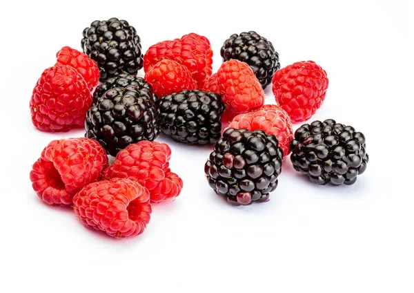 They look like artificial treats! But they are delicious and beautiful blackberries and fresh raspberries. Isolated on white background. Stock Image
