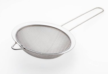 Metallic colander for cooking (kitchenware collection). Isolated on white background. clipart