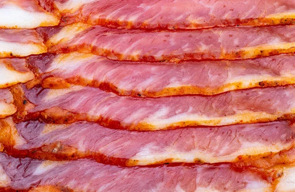 Gros plan de tranches appétissantes de bacon fumé. Avec papier sulfurisé . — Photo