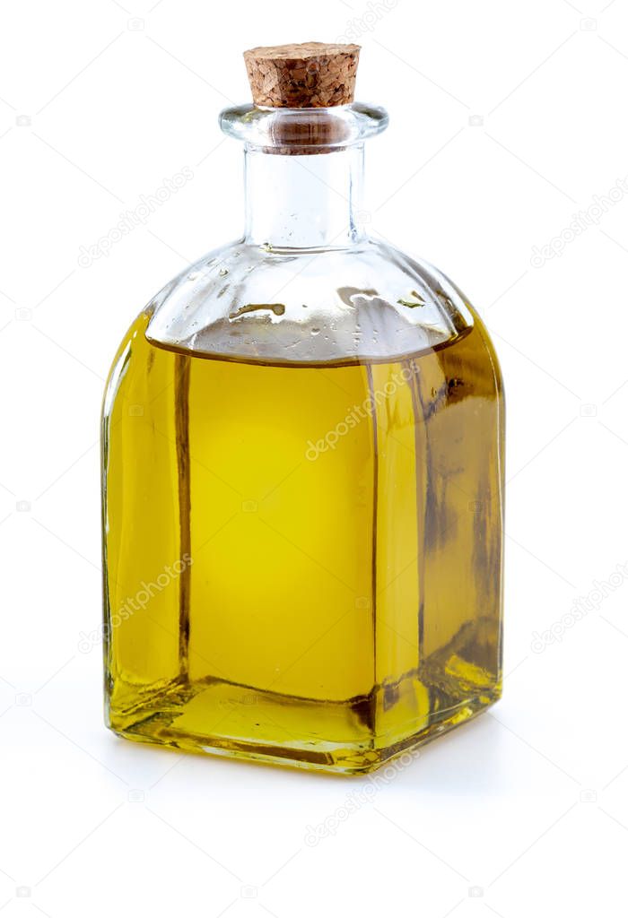 Extra virgin olive oil in glass bottle. Foreground. Includes leaves and olive branches. Isolated on white background.