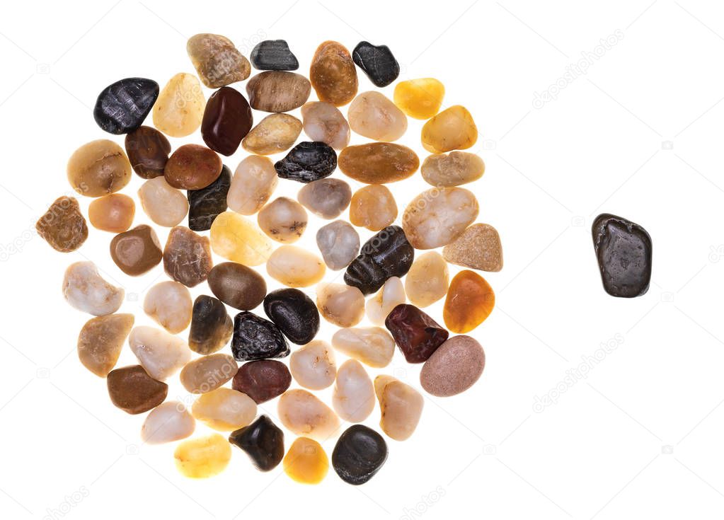 Concept of exclusion and racism made with a group of multi-colored stones (multicolored). Multidisciplinary and multiracial group concept. Isolated on white background Collection made with stones.