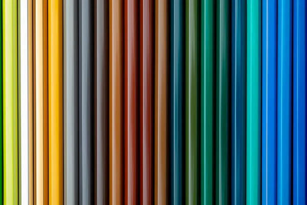 Texture colored pencils. Foreground. Fall and winter colors. Start of school, of classes. Beautiful wallpaper. Color range of ocher, green brown, turquoise and blue.