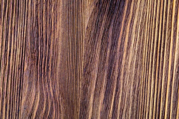 Textura de madeira preciosa. De aspecto rústico e escuro, ocre, marrom, tostado, tons pretos. As veias e nós são apreciados. — Fotografia de Stock