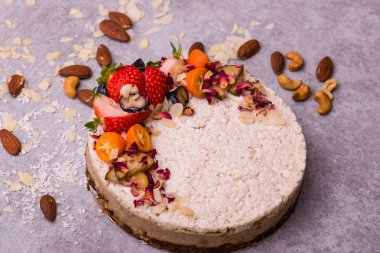 Meyve, çilek ve badem hafif bir arka plan üzerinde beyaz pasta. Çocuk oyuncağı.