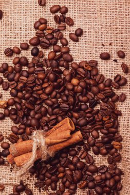 Cafe tasarımı, barlar ve kafeler için resimler. Çuval bezi ve kahverengi zemin closeup kahve taneleri.