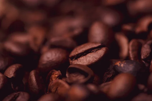 Cafe design, pictures for bars and cafes. Closeup coffee grains on burlap and brown background.