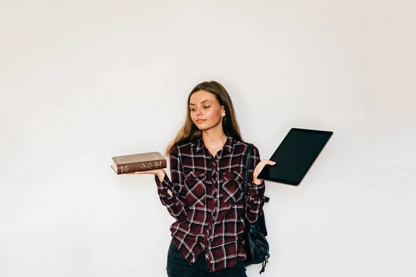 カラフルな背景にある彼女の手の選択で保持電子タブレット学生と新しい紙の本が付いている古い本と電子ブック — ストック写真
