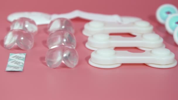 Baby proofing locks lay on pink background slider shot childhood — Stok Video