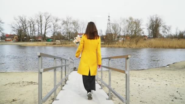 Mädchen mit Blumen auf der Flussfalle verschwinden, Trennungskonzept, traurig — Stockvideo