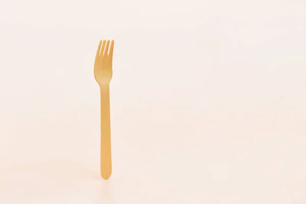 Disposable wooden cutlery forks in hand. The concept of environmental protection, zero waste
