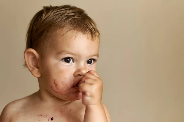 Девочка ест ягоды, грязное лицо, годовалый ребенок. Портрет крупный план — стоковое фото