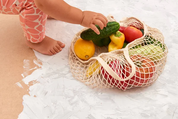 Eco friendly mesh bag with fruit and veggies. Top view. No plastic