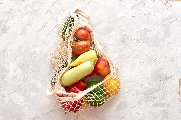 Eco friendly mesh bag with fruit and veggies. Top view. No plastic