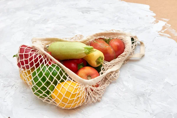 Eco friendly mesh bag with fruit and veggies. Top view. No plastic