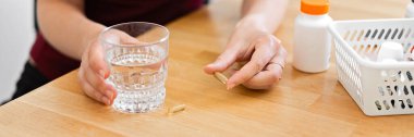 Banner of woman hands drinks a lot of pills. Preventive medicine. Food supplements