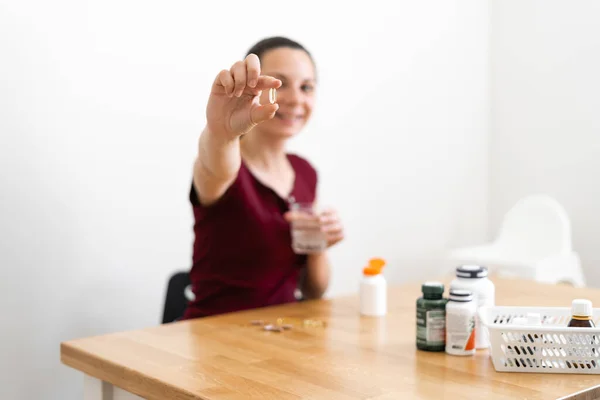 Caucasian woman drinks a lot of pills. Preventive medicine. Food supplements