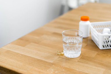 Close up glass with water and sparkling pill. Magnesium anti-stress, painkiller or orange drink clipart
