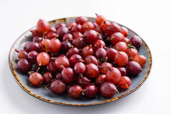 Close up shot of red gooseberry harvest. Healthy lifestyle and eating. Vegan food — Stock Photo, Image