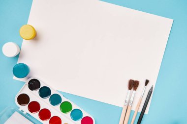 Boya ve fırçanın üst görüntüsü. Tuval maketi. Okul masası manzarası. Sanat sınıfı