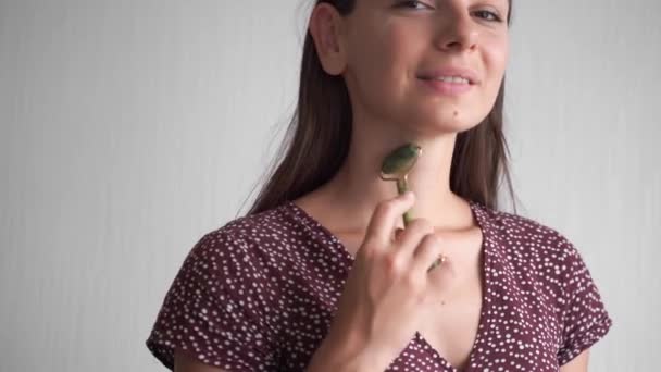 Jeune femme utilisant un rouleau de quartz gemme à la maison. routine naturelle d'autosoin. — Video