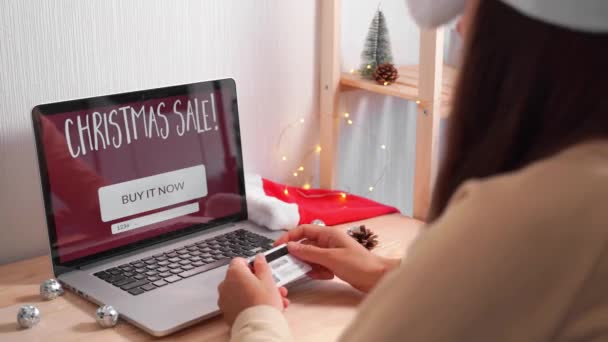Молода жінка купує онлайн подарунки на Різдво з кредитною карткою. онлайн різдвяні покупки. чорна п'ятниця — стокове відео