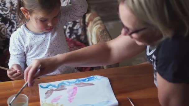 Child with granny drawing with watercolor paint at home. Simple living, connection concept — Stock Video